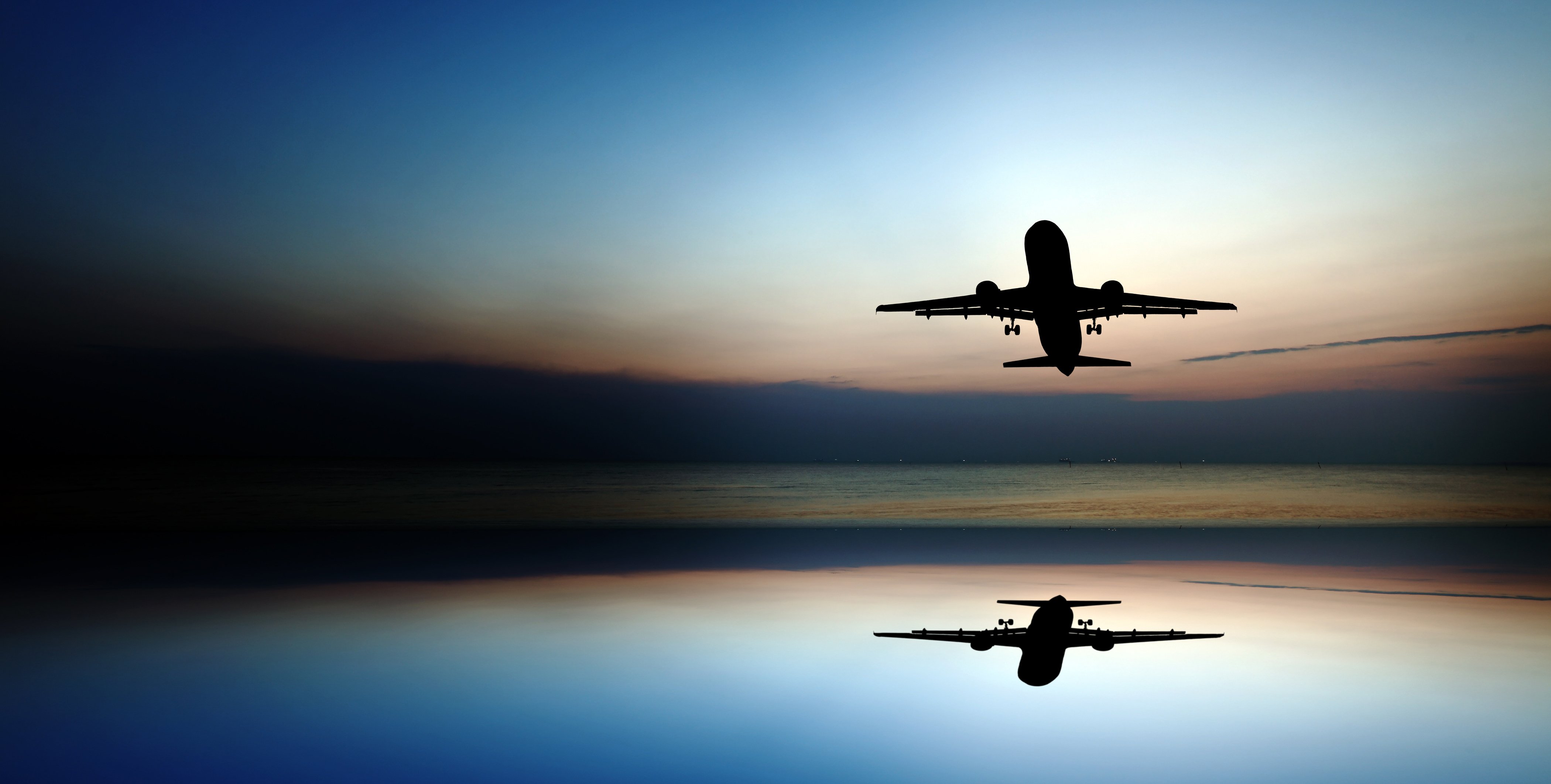 Airplane at gate of airport by night